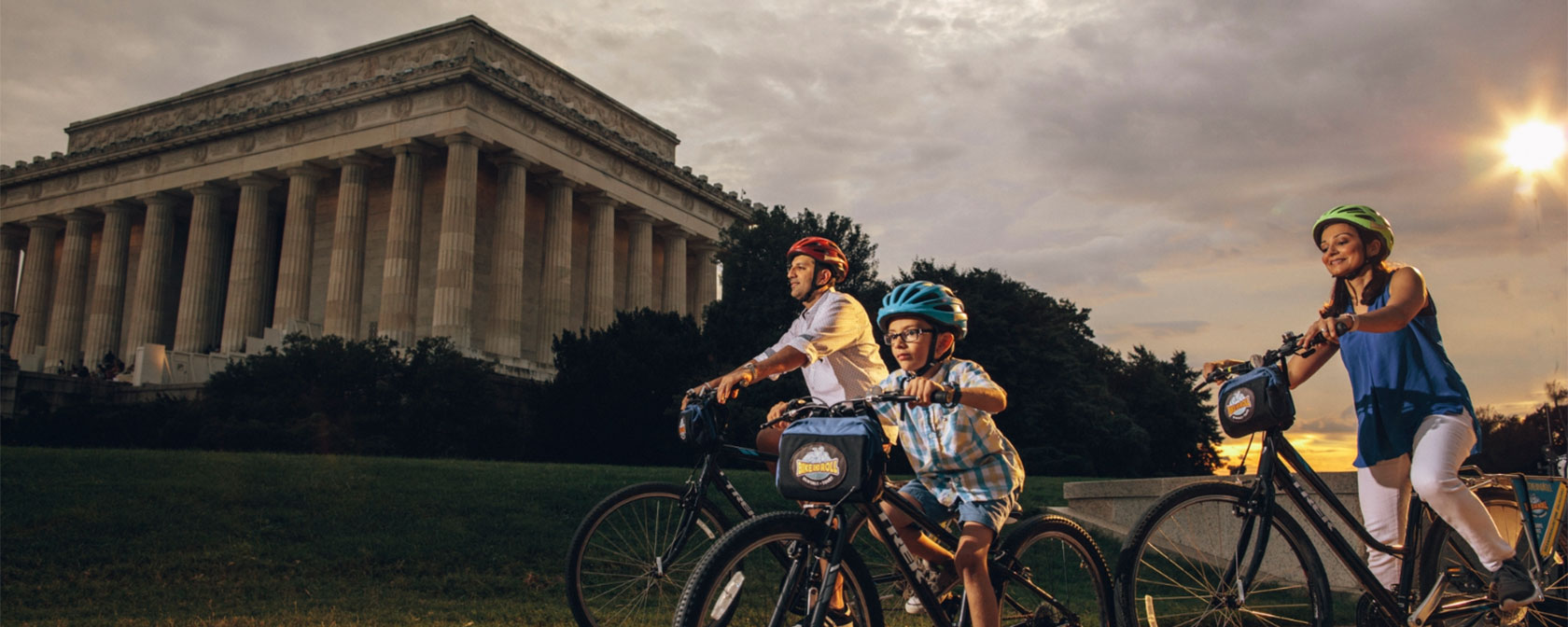 Family biking in front of Lincoln Memorial