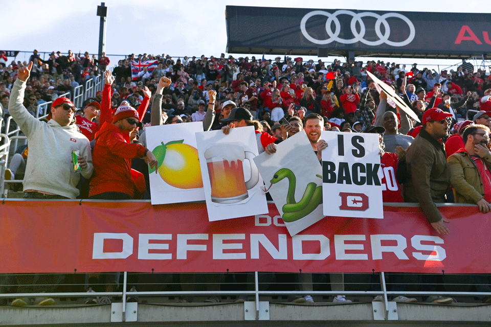 Front row of the crowd holding up BeerSnake signs