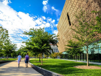 People walking outside in front of National Museum of African AmericanHistory and Culture 