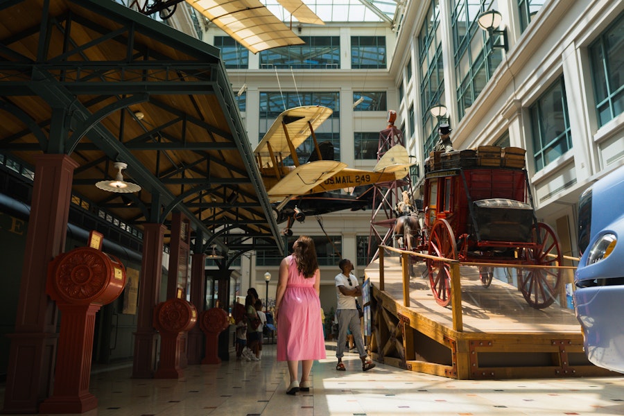 Visitors explore historic transportation displays inside the Smithsonian National Postal Museum.