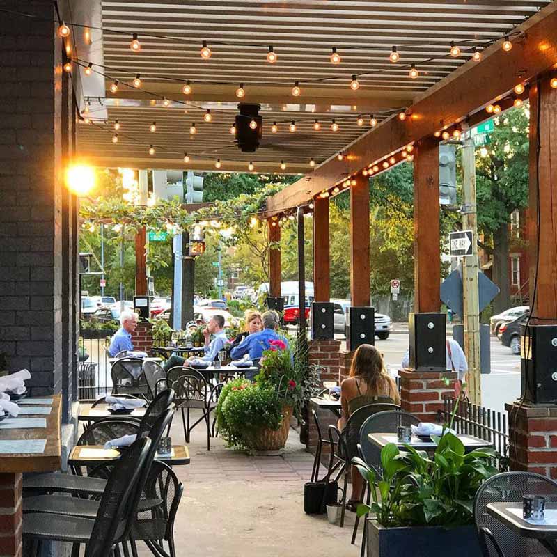 Diners at Tyber Creek Wine Bar and Kitchen on the outdoor patio - Where to eat and drink in Washington, DC's Bloomingdale neighborhood