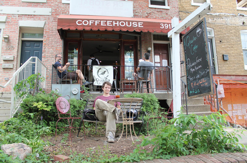 Patron sitting outside Qualia Coffee in Petworth - Neighborhood scenes in Washington, DC