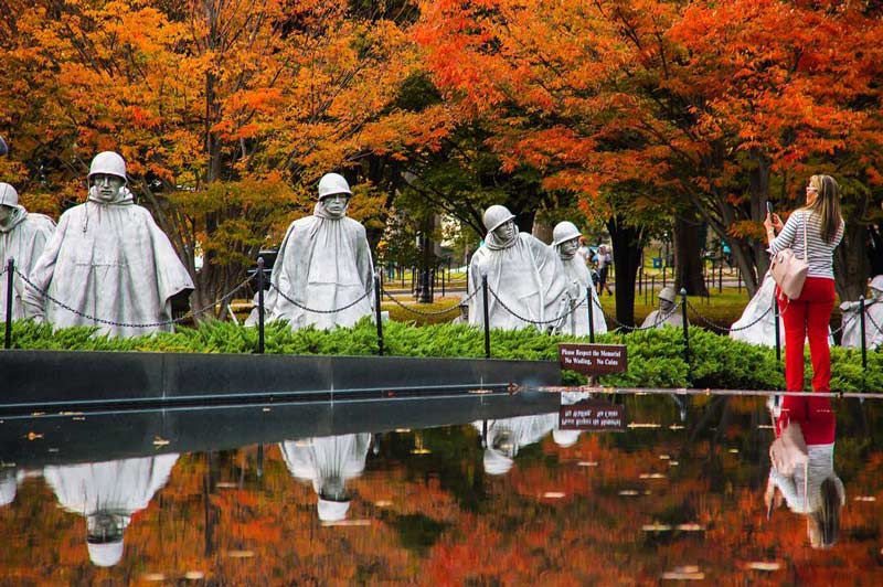 @sinhat25 - Woman taking photo of Korean War Veterans Memorial - Fall foliage in Washington, DC