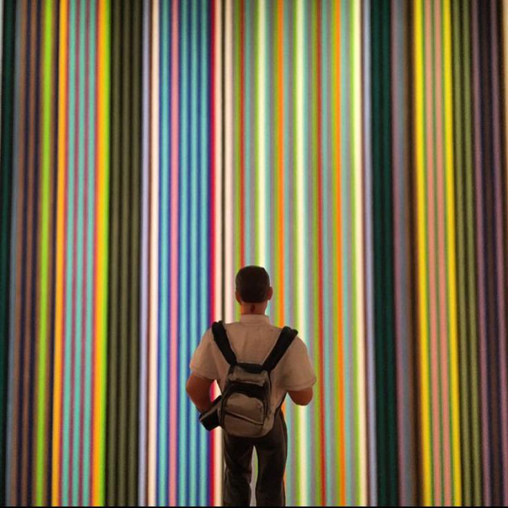 Person standing in front of art at a museum