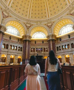 Two people inside the Library of Congress