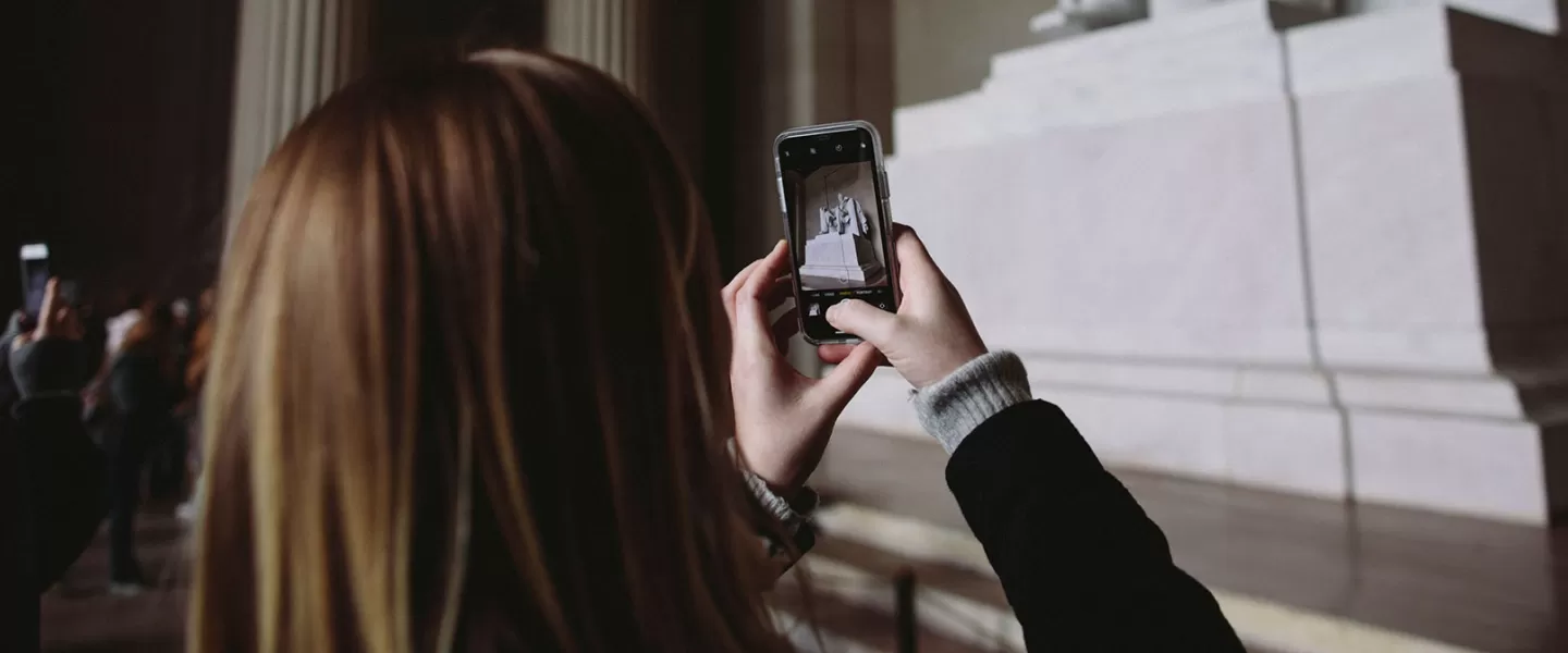 Girl taking photo of Lincoln Memorial