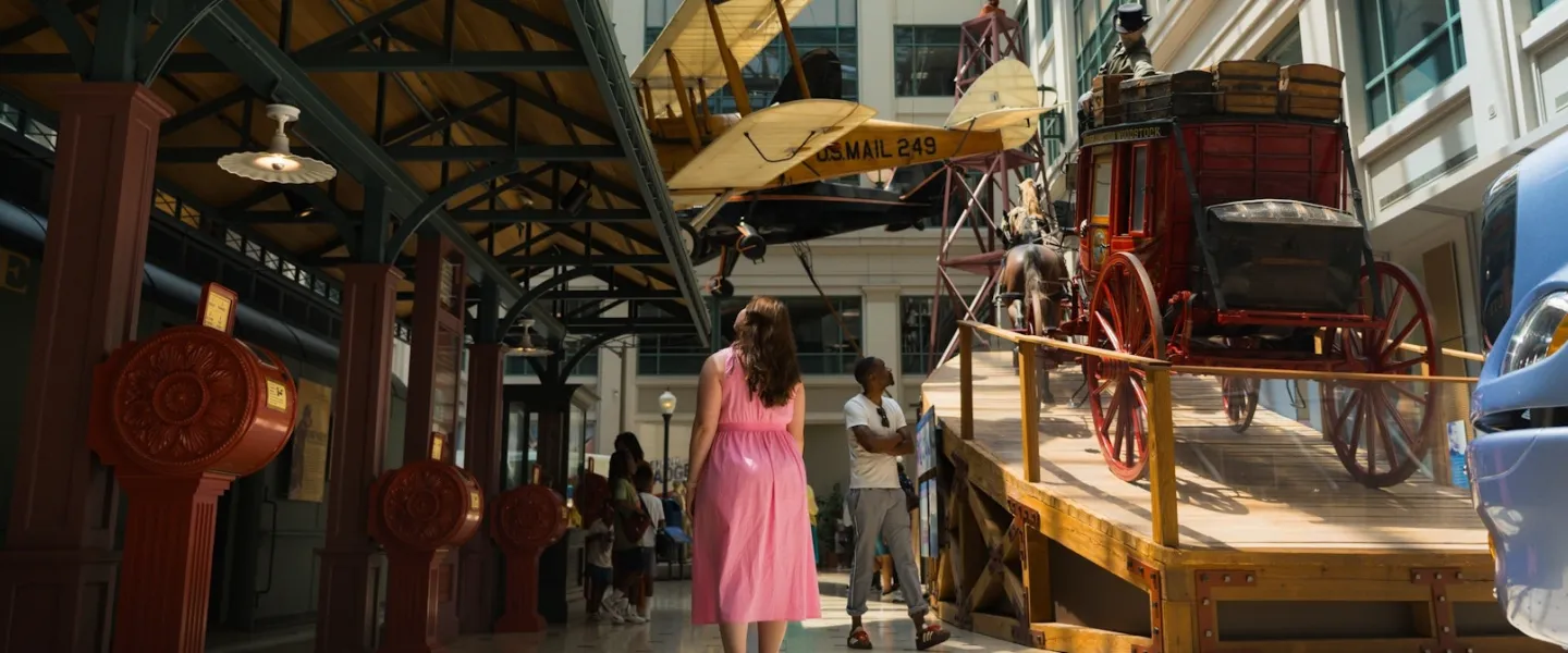 Visitors explore historic transportation displays inside the Smithsonian National Postal Museum.