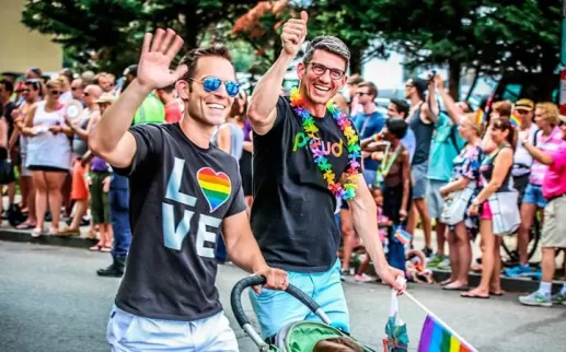 Couple walking with child during Capital Pride Parade - LGBTQ Summer Events in Washington, DC
