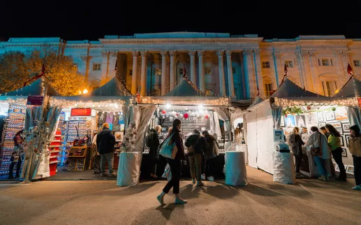 Downtown Holiday Market tents at night
