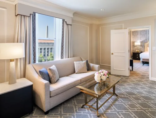 An elegant hotel room with a view of the Washington Monument. 