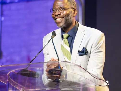 Elliott L. Ferguson II smiling at a podium