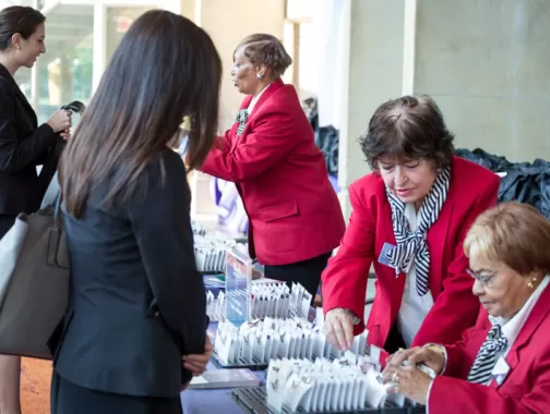 Destination DC Staffing Services redcoat assisting meeting attendee - Staffing solutions for events in Washington, DC