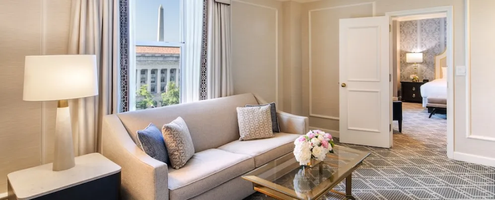 An elegant hotel room with a view of the Washington Monument. 